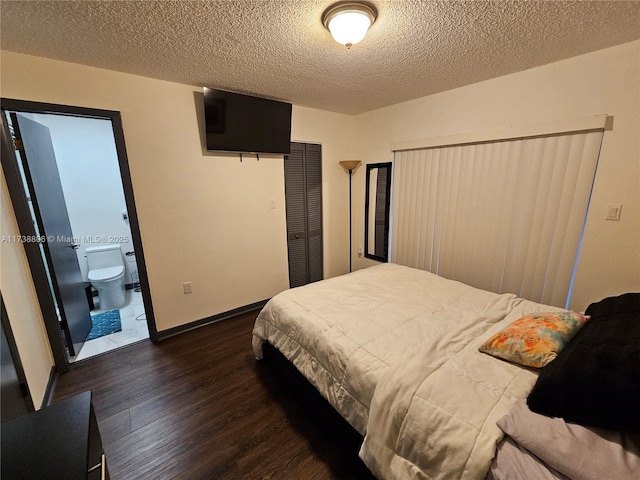 bedroom featuring a closet, dark hardwood / wood-style floors, and a textured ceiling