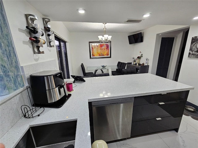 kitchen featuring stainless steel dishwasher, a chandelier, and hanging light fixtures