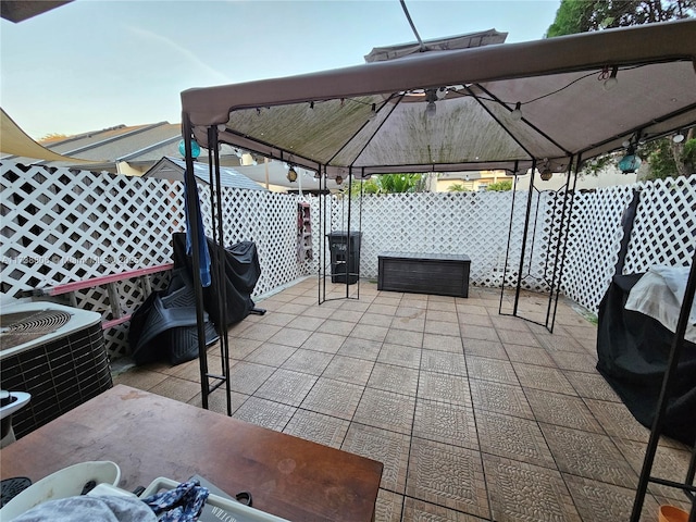 view of patio featuring a gazebo and cooling unit