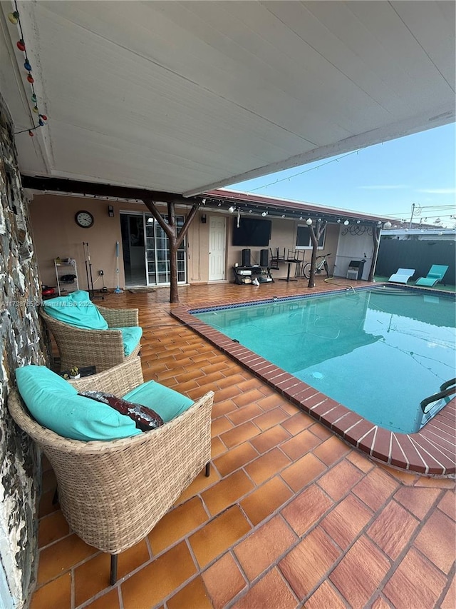 view of swimming pool featuring an outdoor living space and a patio area