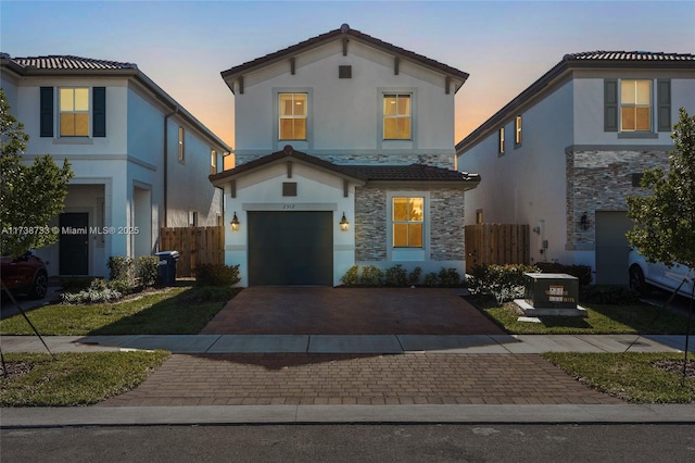 mediterranean / spanish-style home with a garage