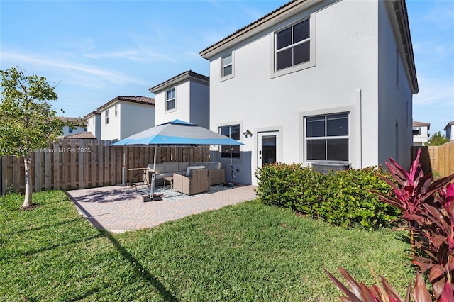 rear view of property featuring an outdoor living space, a patio area, and a lawn