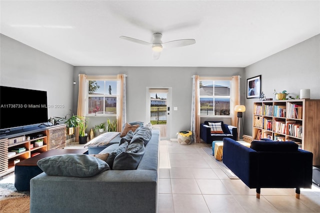 tiled living room featuring ceiling fan