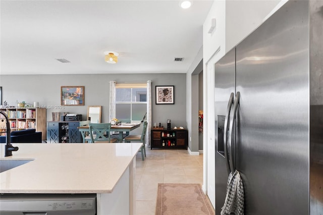 kitchen with appliances with stainless steel finishes and light tile patterned floors