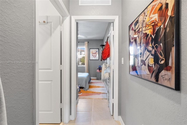 hall with light tile patterned floors