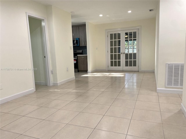 unfurnished room with french doors and light tile patterned flooring