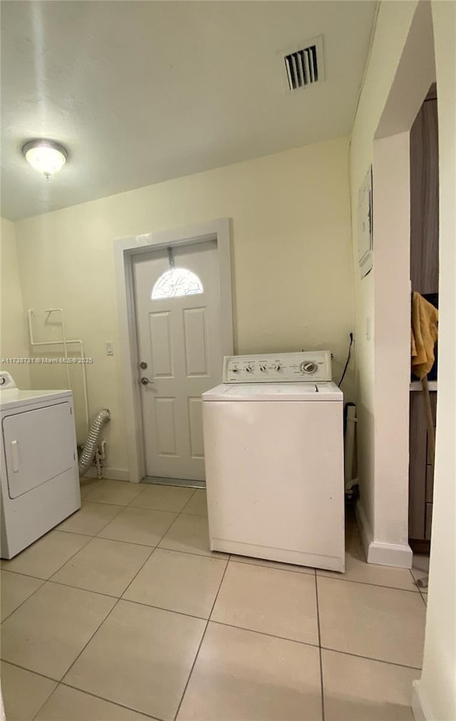 laundry area with light tile patterned flooring