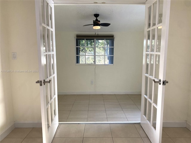 interior space featuring light tile patterned floors and french doors