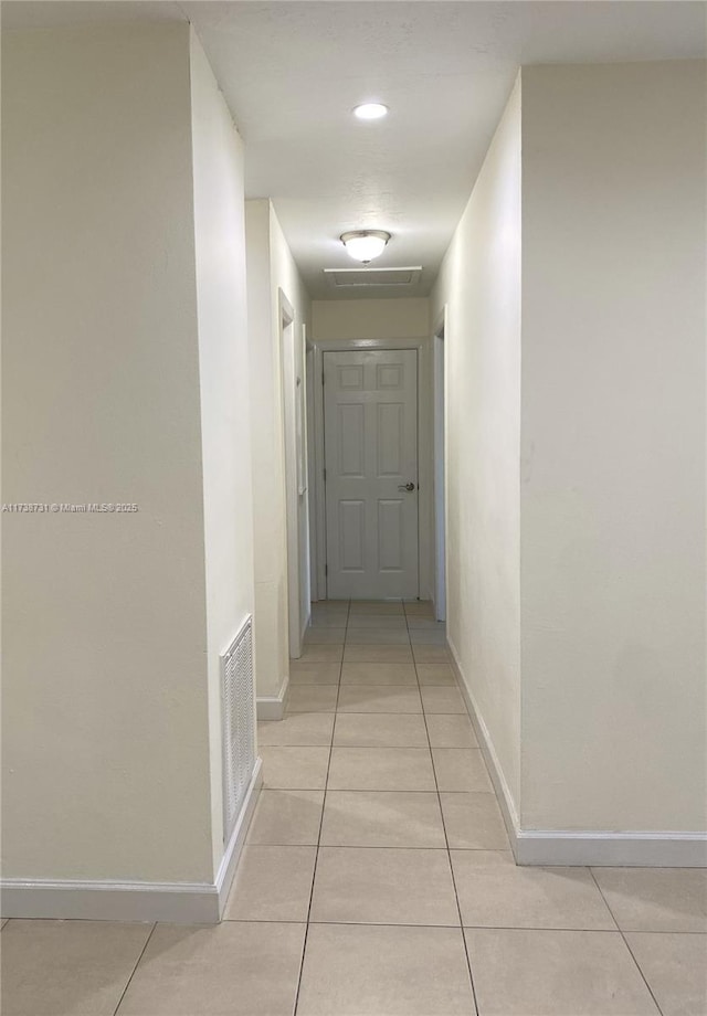 hall featuring light tile patterned floors