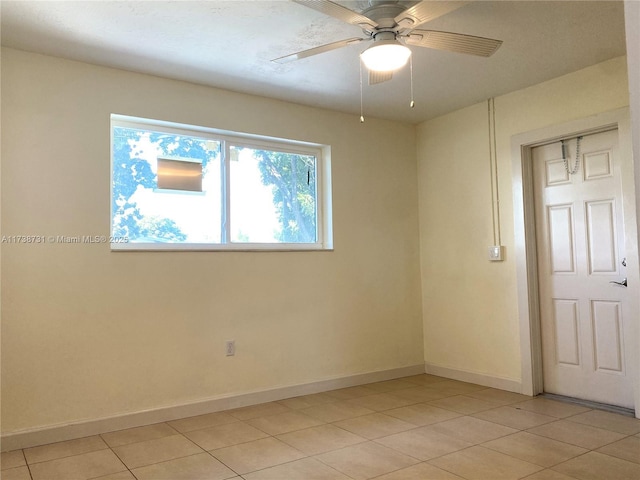 empty room featuring light tile patterned flooring and ceiling fan