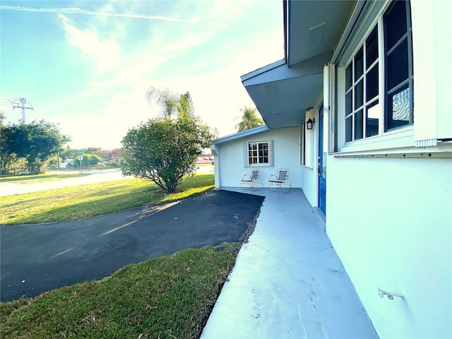 view of home's exterior featuring a patio and a yard