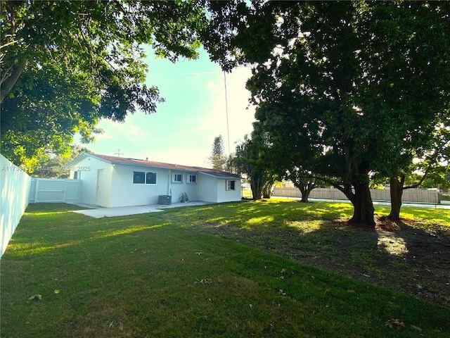 view of yard with central AC unit and a patio area