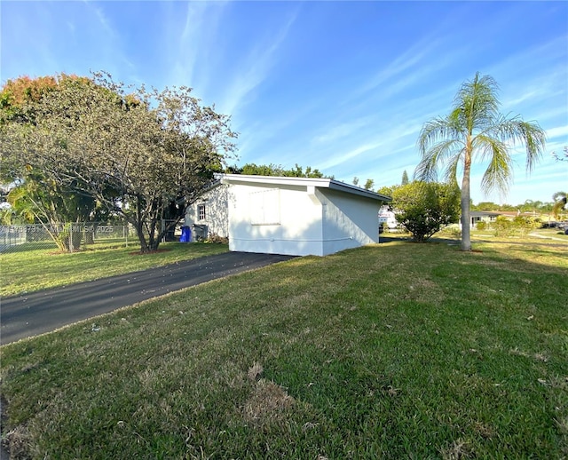 view of side of home with a lawn