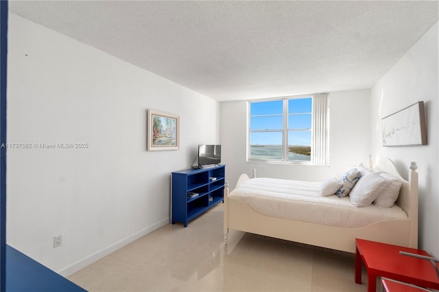 tiled bedroom with a textured ceiling