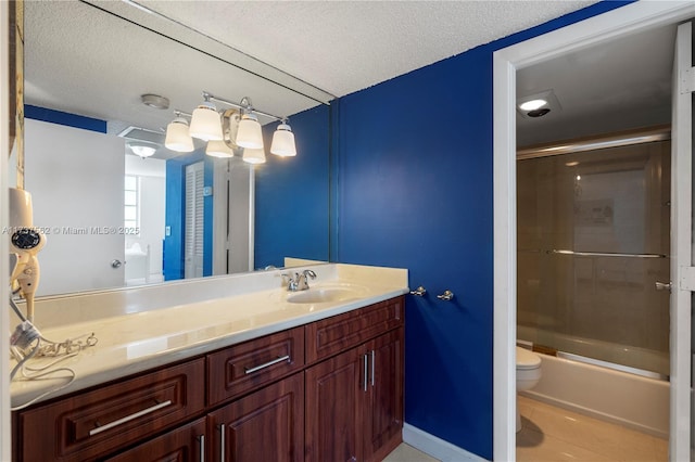 full bathroom with tile patterned floors, toilet, bath / shower combo with glass door, a textured ceiling, and vanity