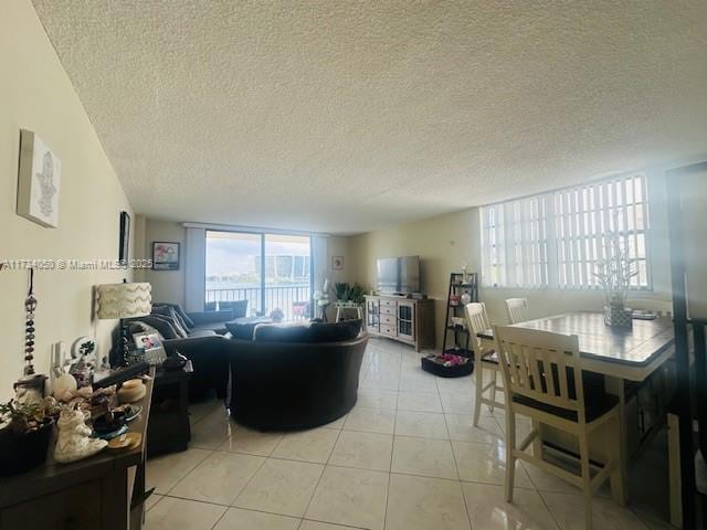 living room featuring light tile patterned floors and a textured ceiling