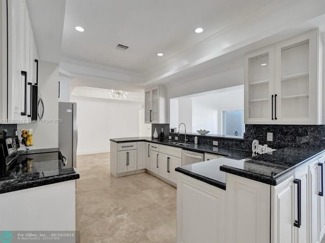 kitchen featuring appliances with stainless steel finishes, sink, white cabinets, and kitchen peninsula