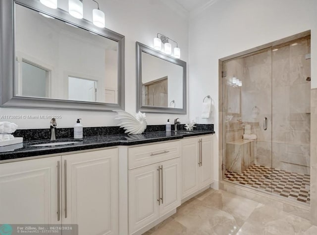 bathroom with vanity, ornamental molding, and an enclosed shower