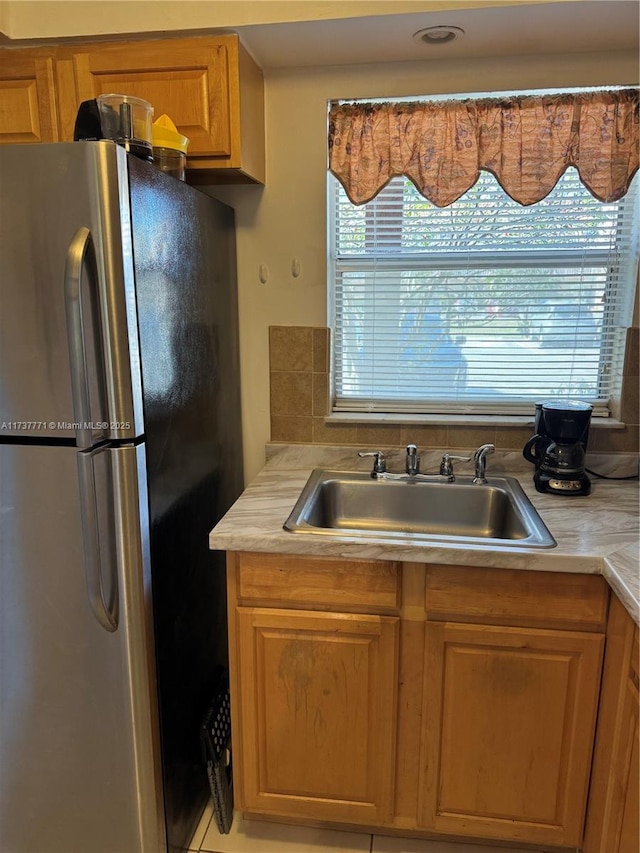 kitchen with sink and stainless steel fridge