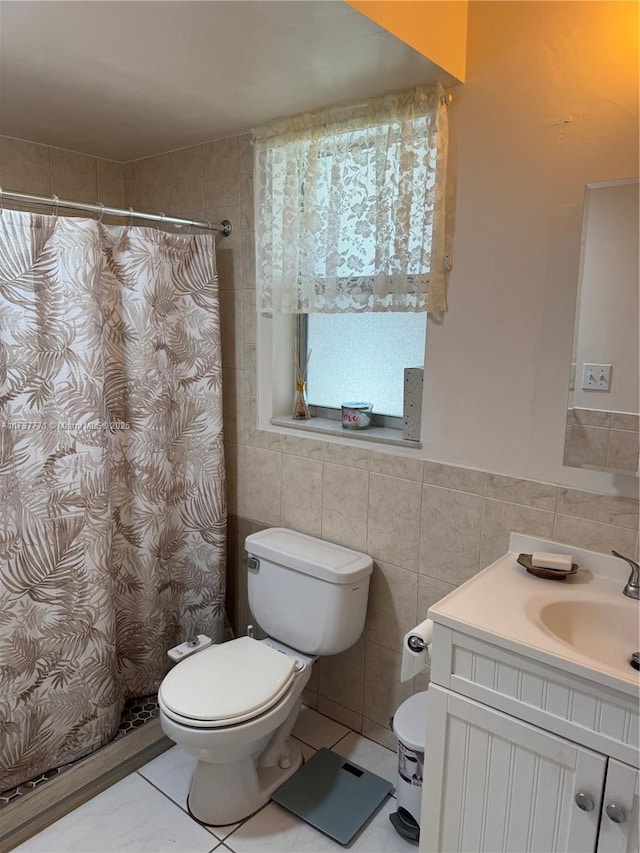 bathroom with vanity, tile walls, walk in shower, and toilet