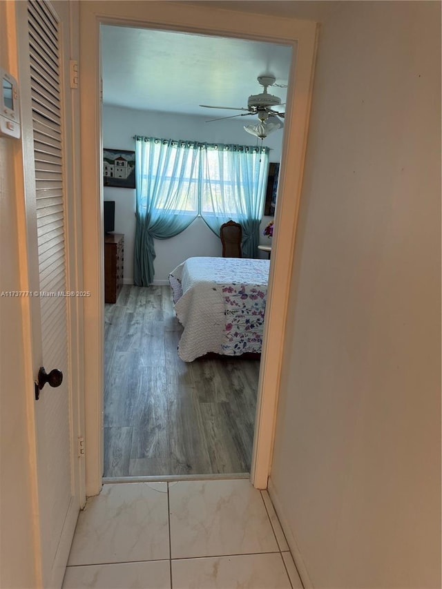 bedroom with light hardwood / wood-style floors and ceiling fan