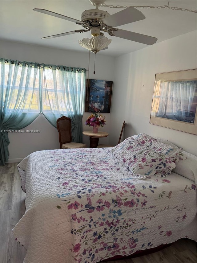 bedroom featuring wood-type flooring and ceiling fan