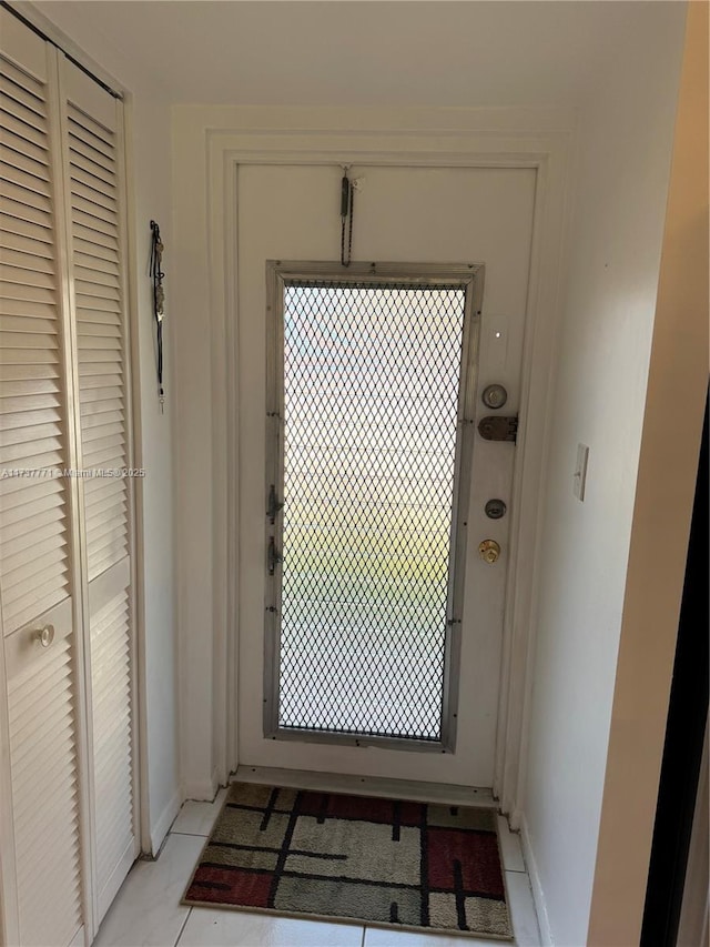 doorway to outside featuring light tile patterned floors