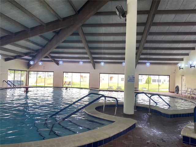 view of swimming pool featuring a hot tub