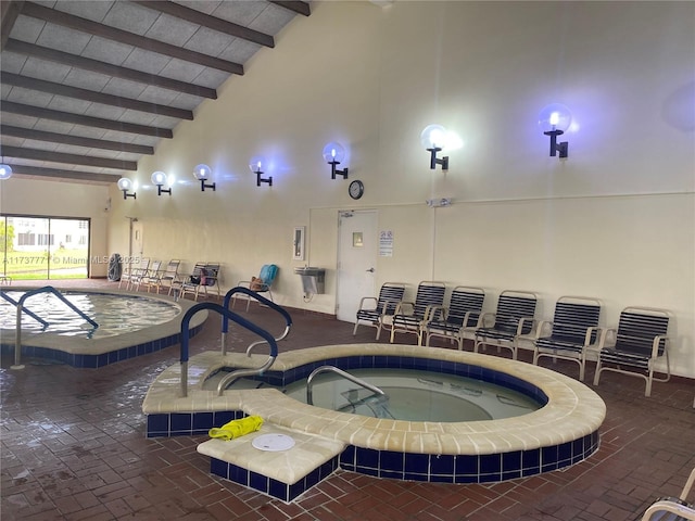 view of swimming pool with an indoor in ground hot tub