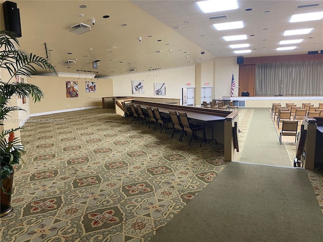 interior space featuring carpet flooring and a paneled ceiling