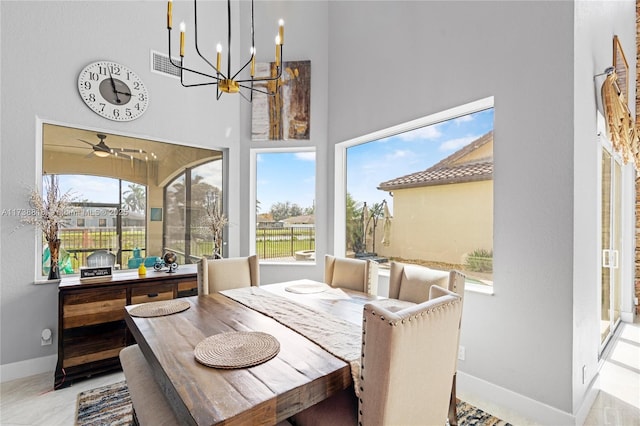 dining room featuring ceiling fan and a high ceiling