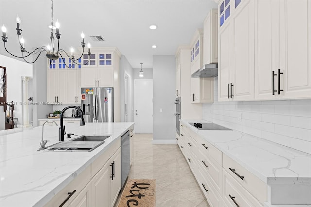 kitchen featuring white cabinetry, sink, decorative light fixtures, and appliances with stainless steel finishes