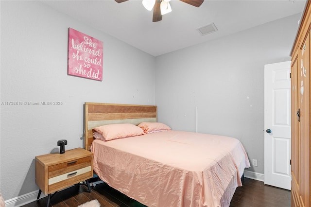 bedroom with ceiling fan and dark hardwood / wood-style flooring