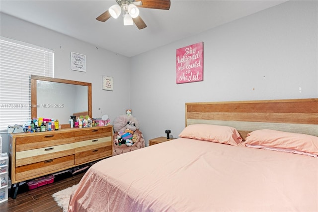 bedroom with dark hardwood / wood-style floors and ceiling fan