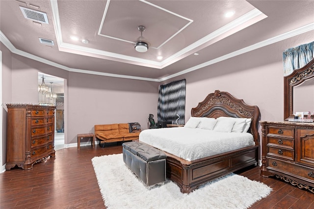 bedroom with crown molding, ceiling fan, dark hardwood / wood-style flooring, and a raised ceiling