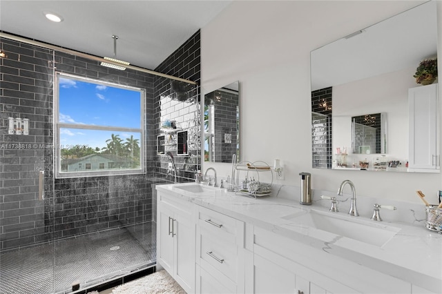 bathroom with vanity and a shower with shower door