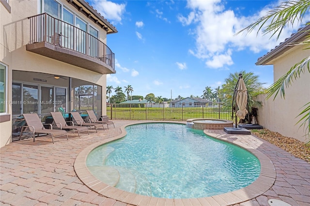 view of pool with a patio, ceiling fan, and an in ground hot tub