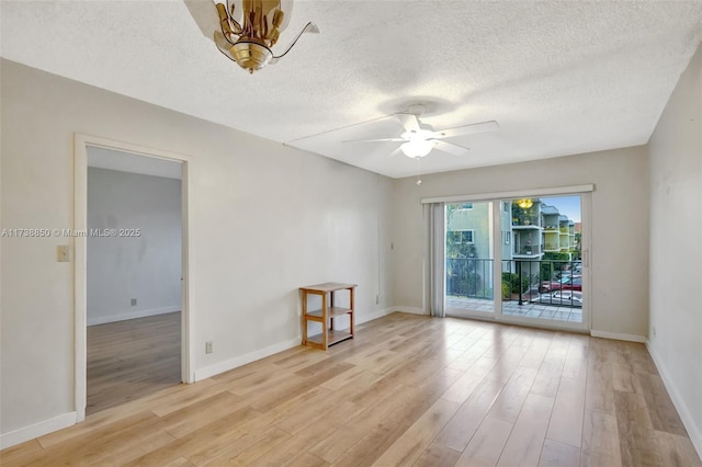 empty room featuring a textured ceiling, light hardwood / wood-style flooring, and ceiling fan