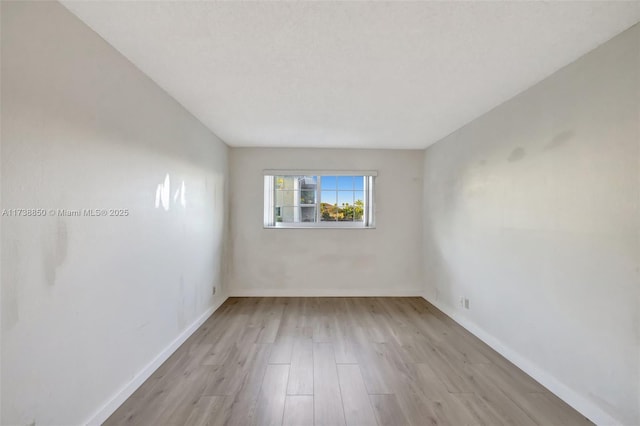 spare room with light hardwood / wood-style floors