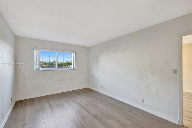 spare room with light wood-type flooring