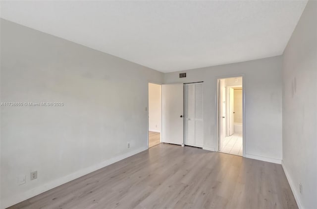 unfurnished room with light hardwood / wood-style flooring