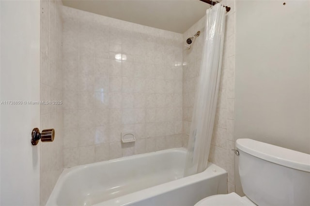 bathroom featuring shower / bathtub combination with curtain and toilet