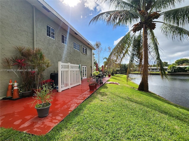 view of yard featuring a patio and a water view