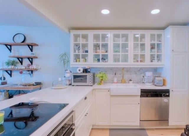 kitchen with sink, stainless steel appliances, and white cabinets