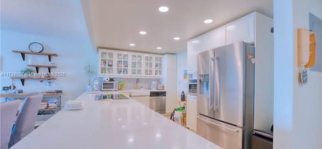 kitchen with appliances with stainless steel finishes and white cabinets