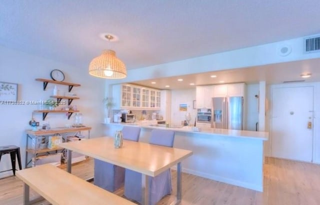 dining space featuring light wood-type flooring