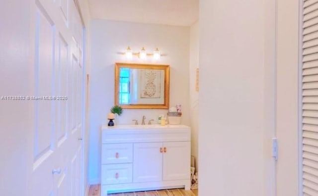 bathroom with hardwood / wood-style flooring and vanity