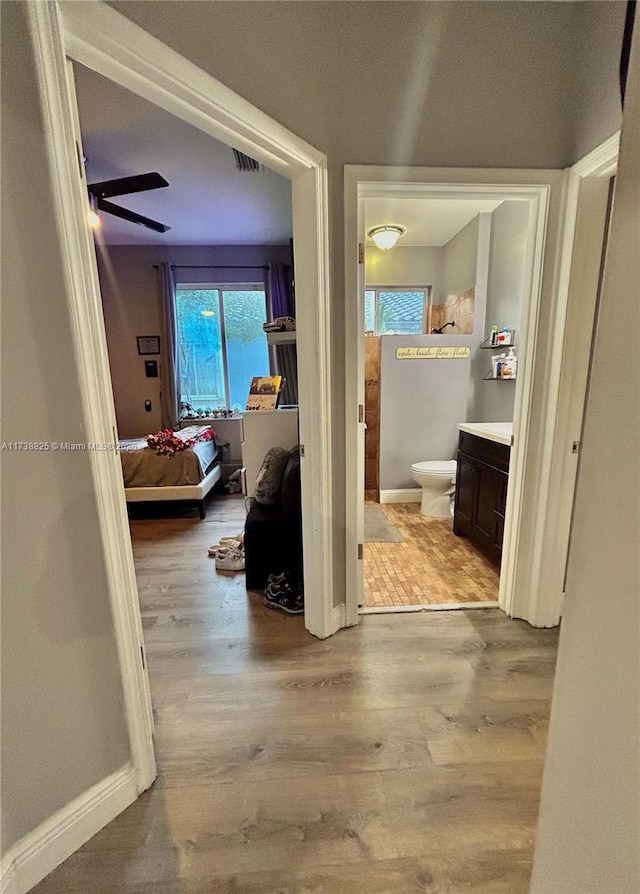 hallway with light hardwood / wood-style floors