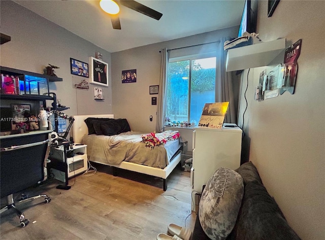 bedroom with wood-type flooring and ceiling fan