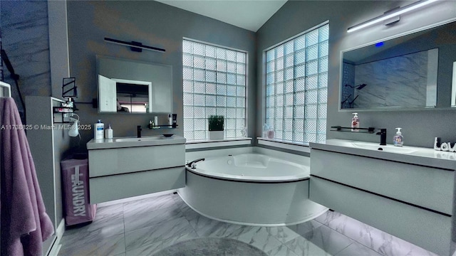 bathroom featuring vanity, lofted ceiling, and a bath